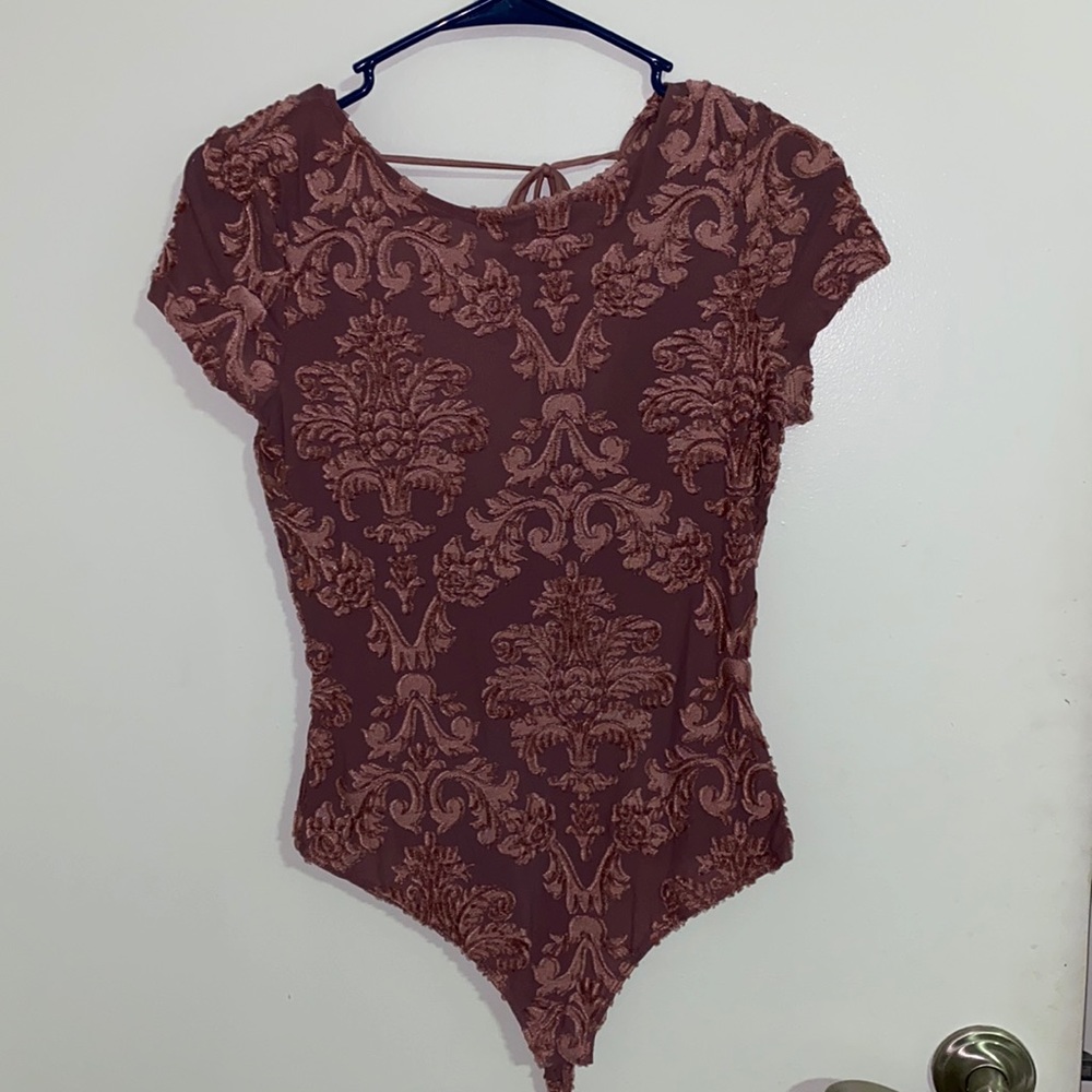 Chic blush bodysuit with floral detail